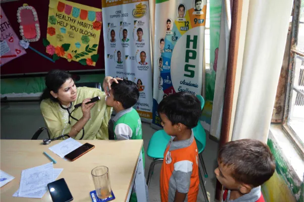 School infirmary nurse checking student’s health in infirmary room